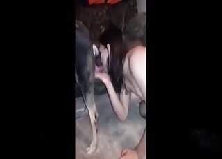 Black-haired beauty gets really wet while sucking dog's dick on cam